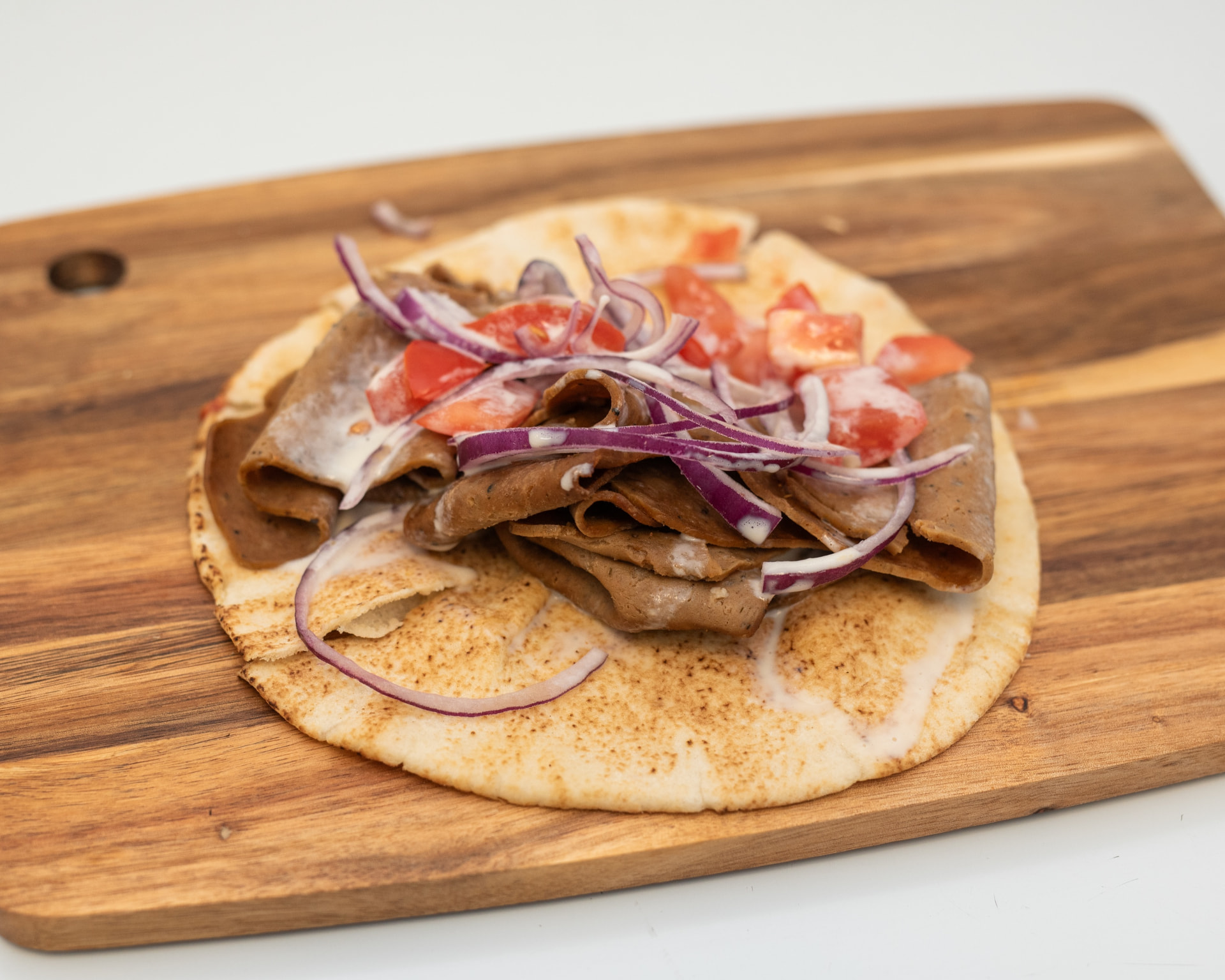 Halifax-style donair on warm pita with onion, tomato and sweet donair sauce